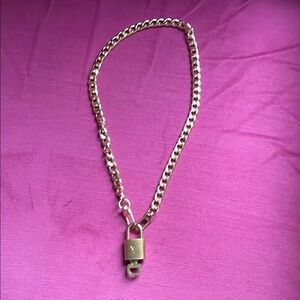 Authentic lv lock and key with new unbranded Gold plated chain.